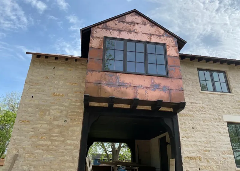 Copper metal panel facade on a stone building for Skylight Installation in Anderson